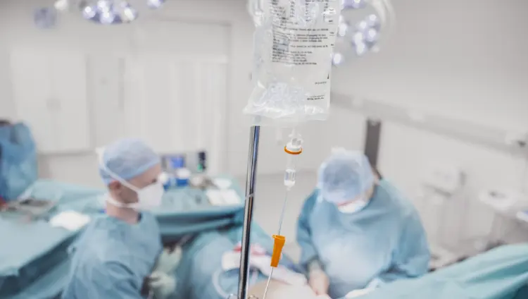 blurred image of doctors making preparations in surgical room